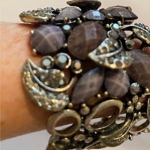 Cuff bracelet with tons of rhinestones and purple stones